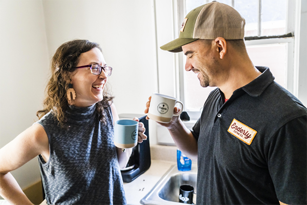 Image of Becky and Tony Santoro smiling and drinking coffee