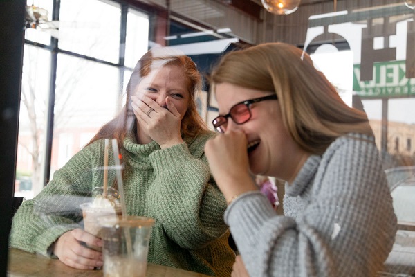 image of Lindsey Chambers and woman laughing at a coffee shop
