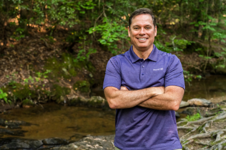 Truist teammate Mark Case stands in front of a creek while on a hike